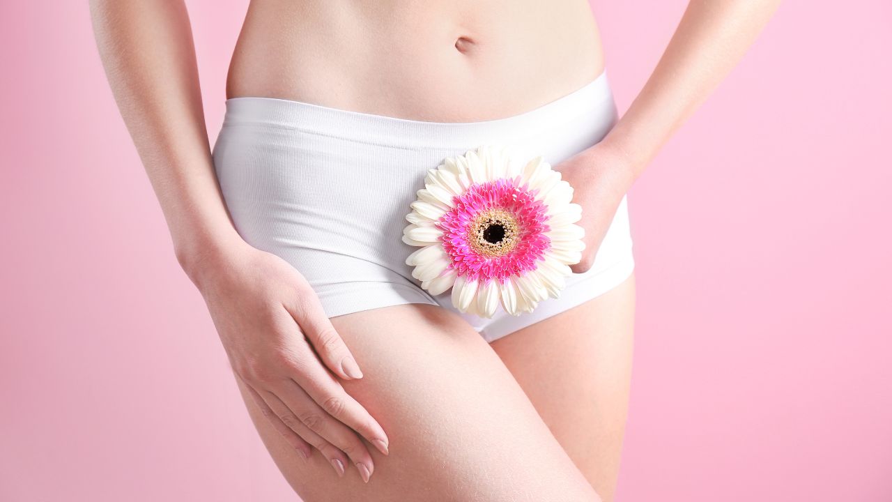 Image of a woman wearing panties with a flower covering them