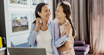Daughter hugging her mom from behind, cherishing the moment.