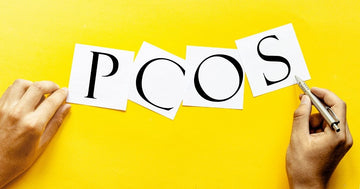 Image of PCOS written on pieces of paper placed on a yellow-colored board.
