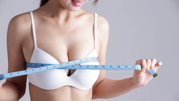 Image of a women measuring her bust