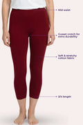 A model wearing capri leggings with text callouts pointing to features like mid-waist, cusset crotch, stretchy fabric, and 3/4 length on a pale pink background.