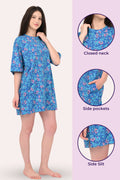 Woman wearing a blue floral dress with close-up details on a white background