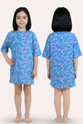 A girl modela blue dress with a pink and light blue floral pattern, shown from both the front and back views.