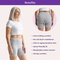 Woman wearing grey shorts with product benefits listed on a light pink background