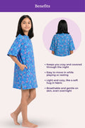 A girl wearing a blue patterned nightshirt with a benefits.