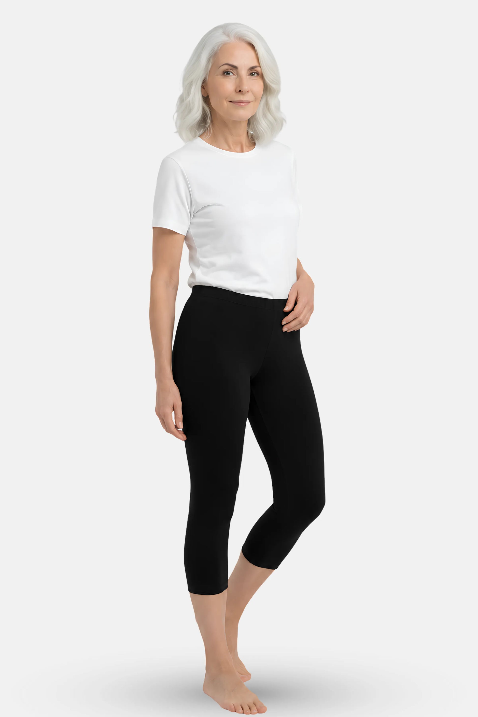 An elder woman wearing a white t-shirt and black high-waisted capri leggings.
