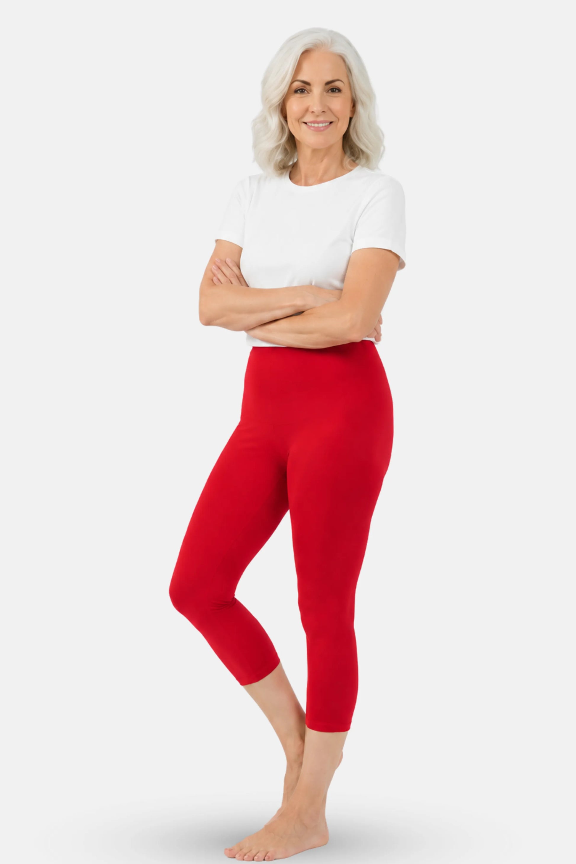 A elder woman wearing bright red high-waisted capri leggings and a white top.