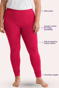A model wearing dark pink leggings with overlaid callout labels pointing to the mid-waist, gusset crotch, stretchy fabric, and churidar hem on a pale background.