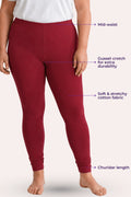 A model wearing churidar leggings with text callouts pointing to the mid-waist, gusset crotch, stretchy fabric, and churidar length on a light beige background.
