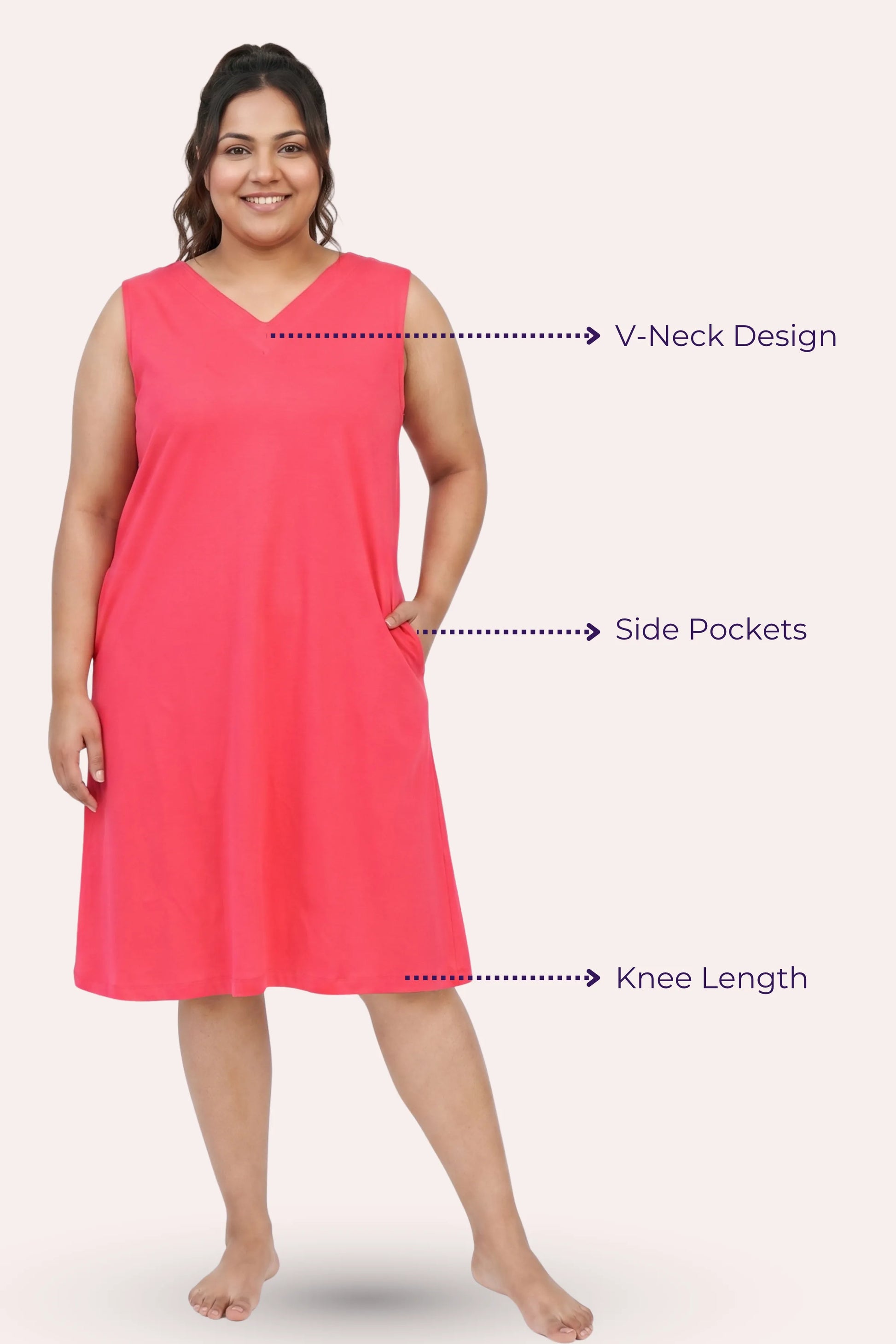 A woman modeling a sleeveless dark pink nightgown with a V-neck, side pockets, and knee-length.