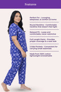 Woman wearing a navy hearts pajama set with text detailing features