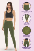 Woman wearing green leggings with product features on a pink background