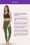 Woman wearing a black sports bra and green leggings with product features listed on a white background