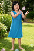 A girl wearing a sleeveless peacock blue dress.