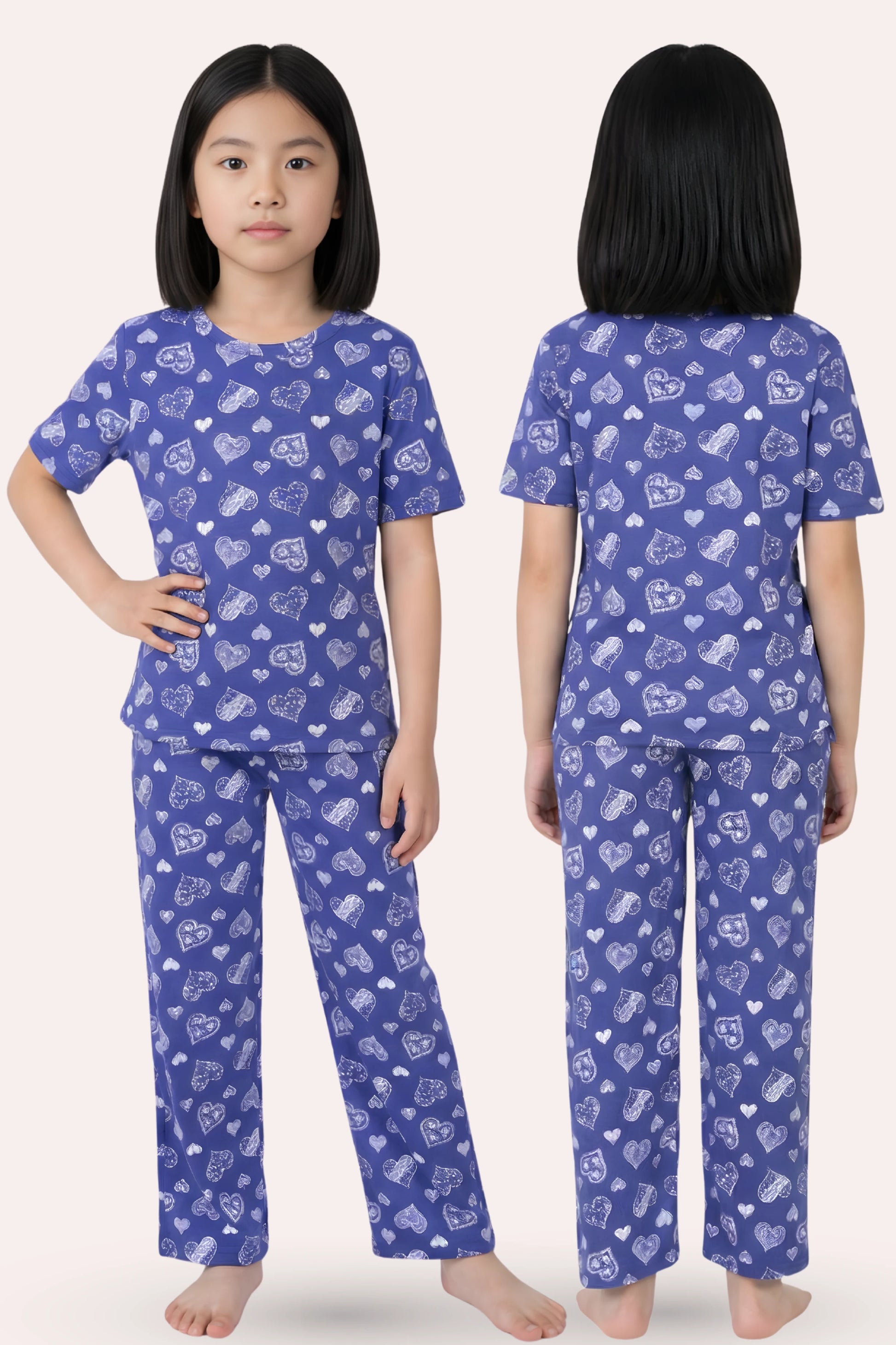Child wearing a navy hearts pajama set with white patterns