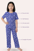 Girl wearing a navy hearts pajama set with text labels