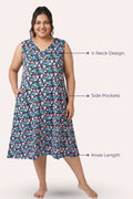 A woman modeling a sleeveless knee-length dress with a black print, with callout features.
