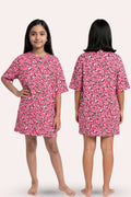 A young girl modeling a pink nightgown hearts pattern, shown from both the front and back views.
