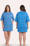 A woman model a blue floral t-shirt, shown from both the front and back view.