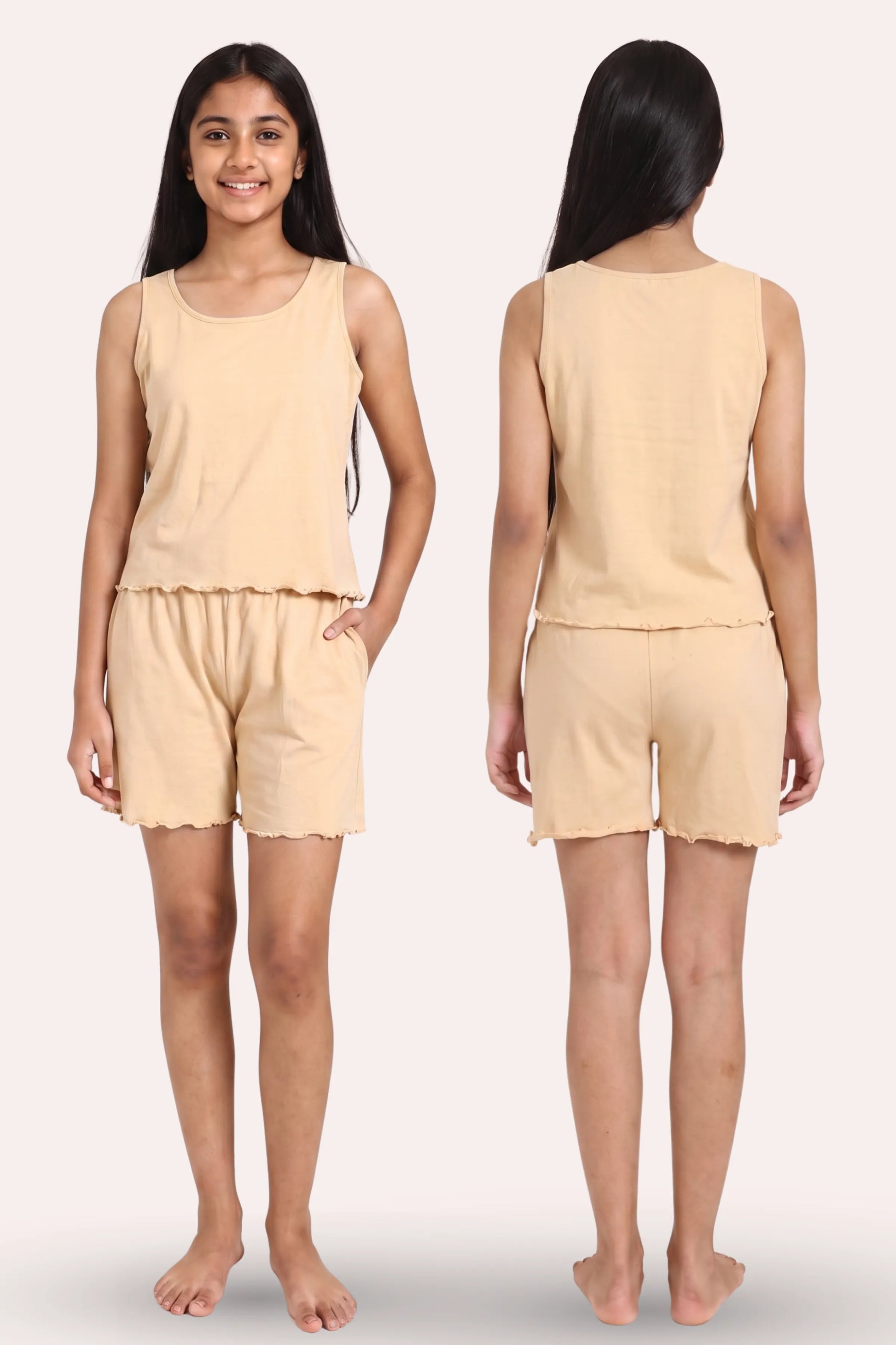 A girl model shown from the front and back wearing a sleeveless ruffled top and matching shorts in a light beige color, against a plain light background.