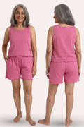 A woman modeling a sleeveless pink two-piece lounge set with matching shorts, shown from both the front and back views against a plain light background.