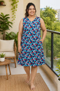 A woman wearing a sleeveless V-neck nightgown with a blue floral pattern.