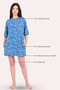 Woman wearing a blue floral dress with labeled features on a white background