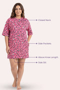 A woman model a pink patterned nightshirt with text callouts pointing to features.