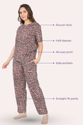 Woman wearing a brown leopard print pajama set with labeled features
