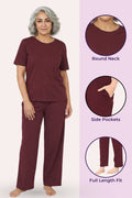 Woman wearing a wine outfit with round neck, side pockets, and full length fit