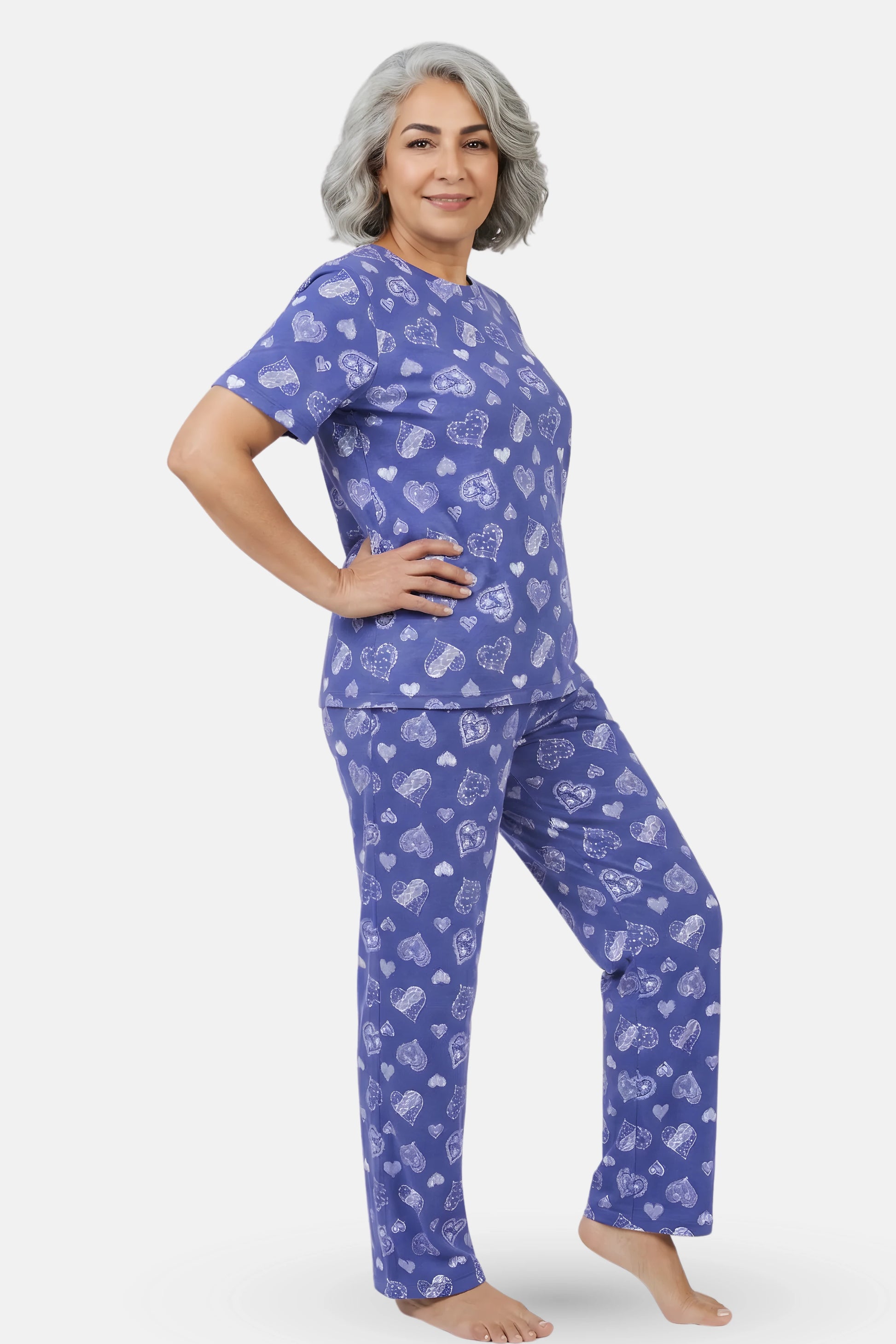 Woman wearing a navy hearts pajama set with white patterns