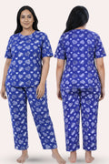 Woman wearing a navy hearts pajama set with heart pattern, front and back views