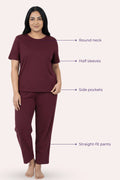 Woman wearing a wine pajama set with labeled features