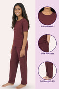 Teen wearing wine pajama set with product details