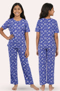 Teen wearing a navy heart pajama set front and back pose