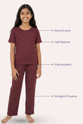Teen wearing a maroon outfit with labeled features