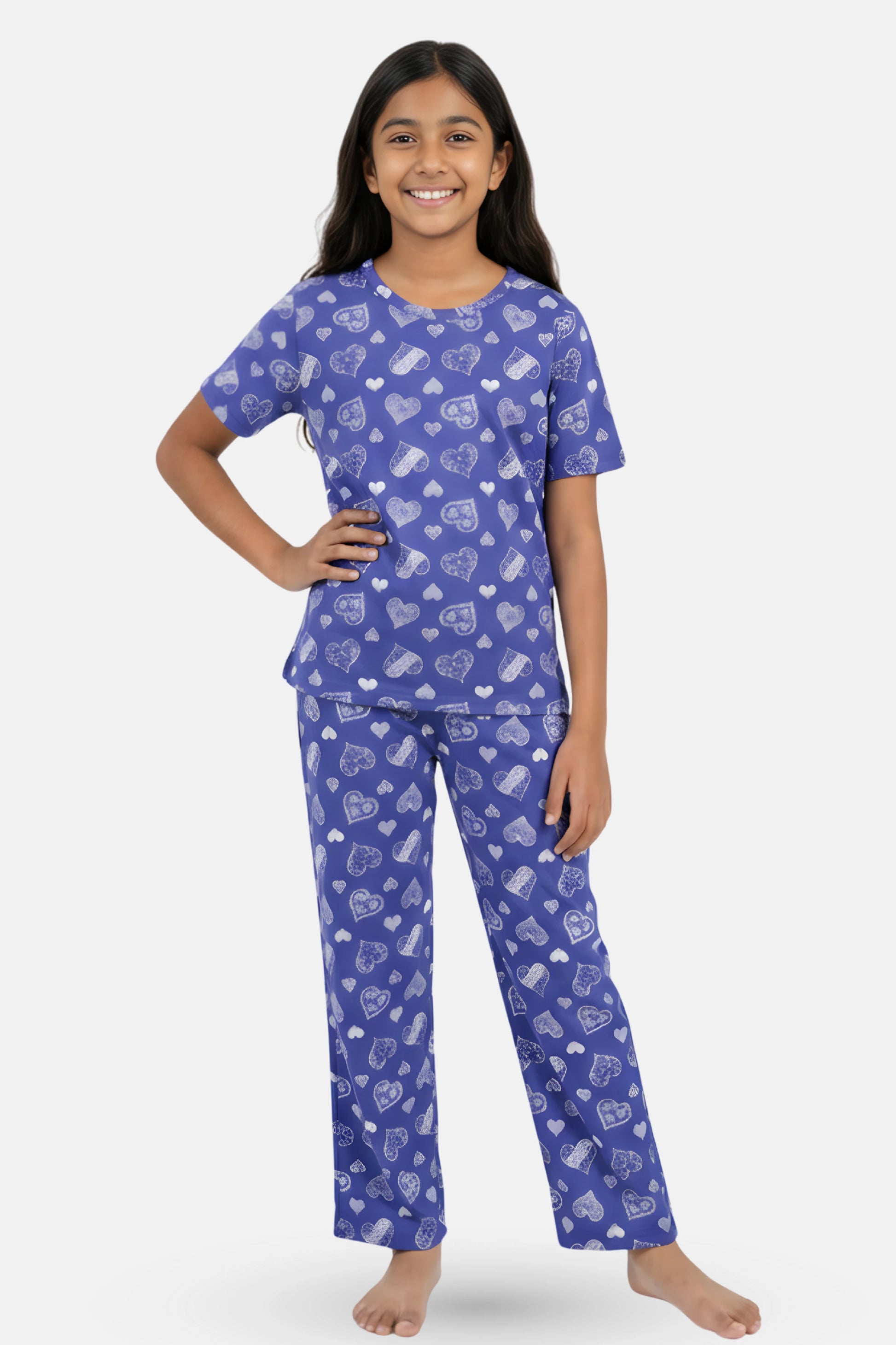 Teen wearing a navy hearts pajama set with heart patterns
