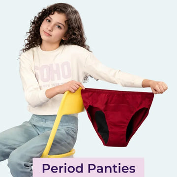 Teen sitting in a chair while holding the period panties.