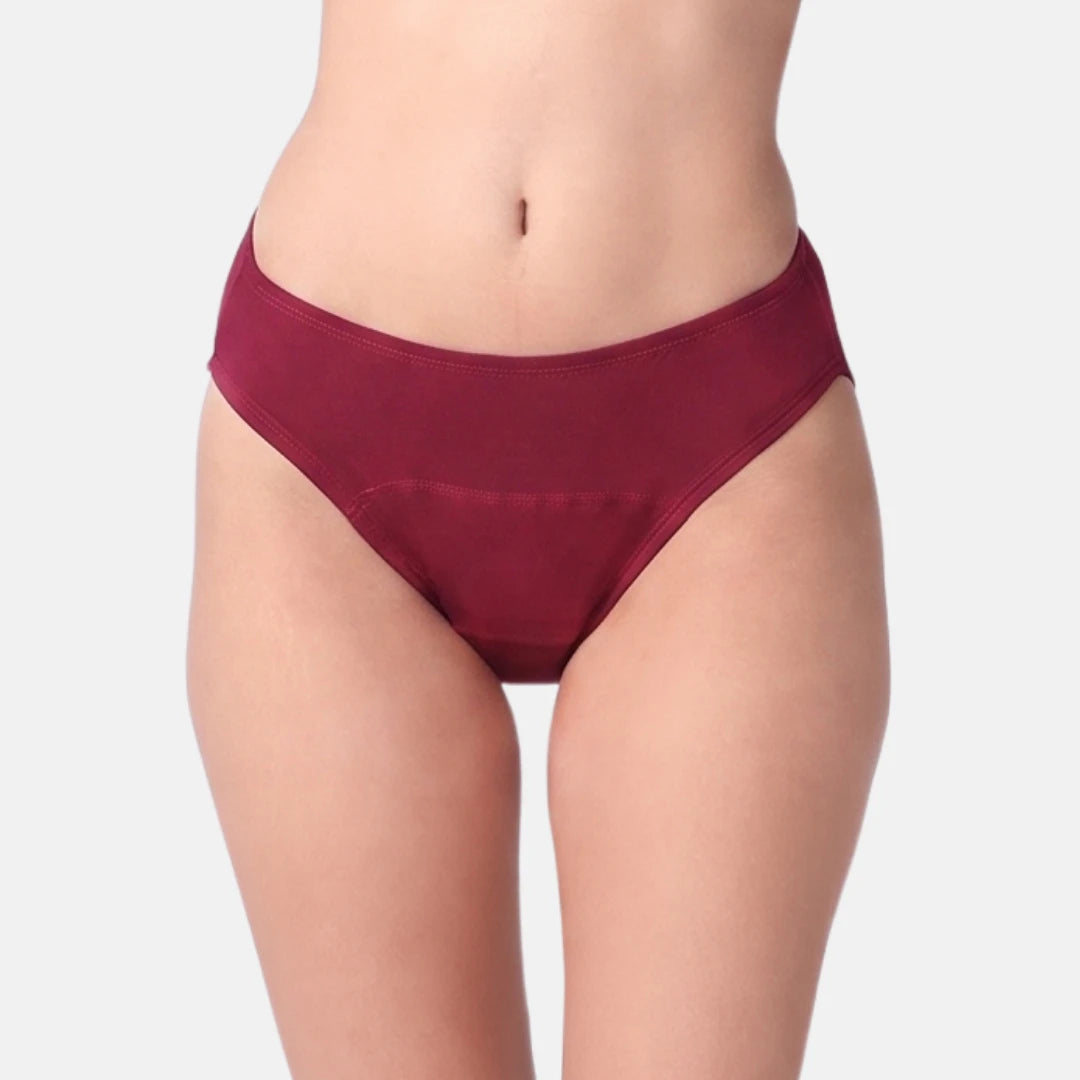 A close-up of a model's lower torso wearing a maroon color, set against a plain light gray background.