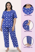 Woman wearing a navy hearts pajama set with heart patterns, standing against