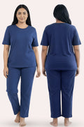Woman wearing a airforce navy pajama set, shown from front and back