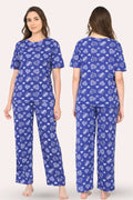 Woman wearing a navy pajama set with hearts patterns, shown from front and back