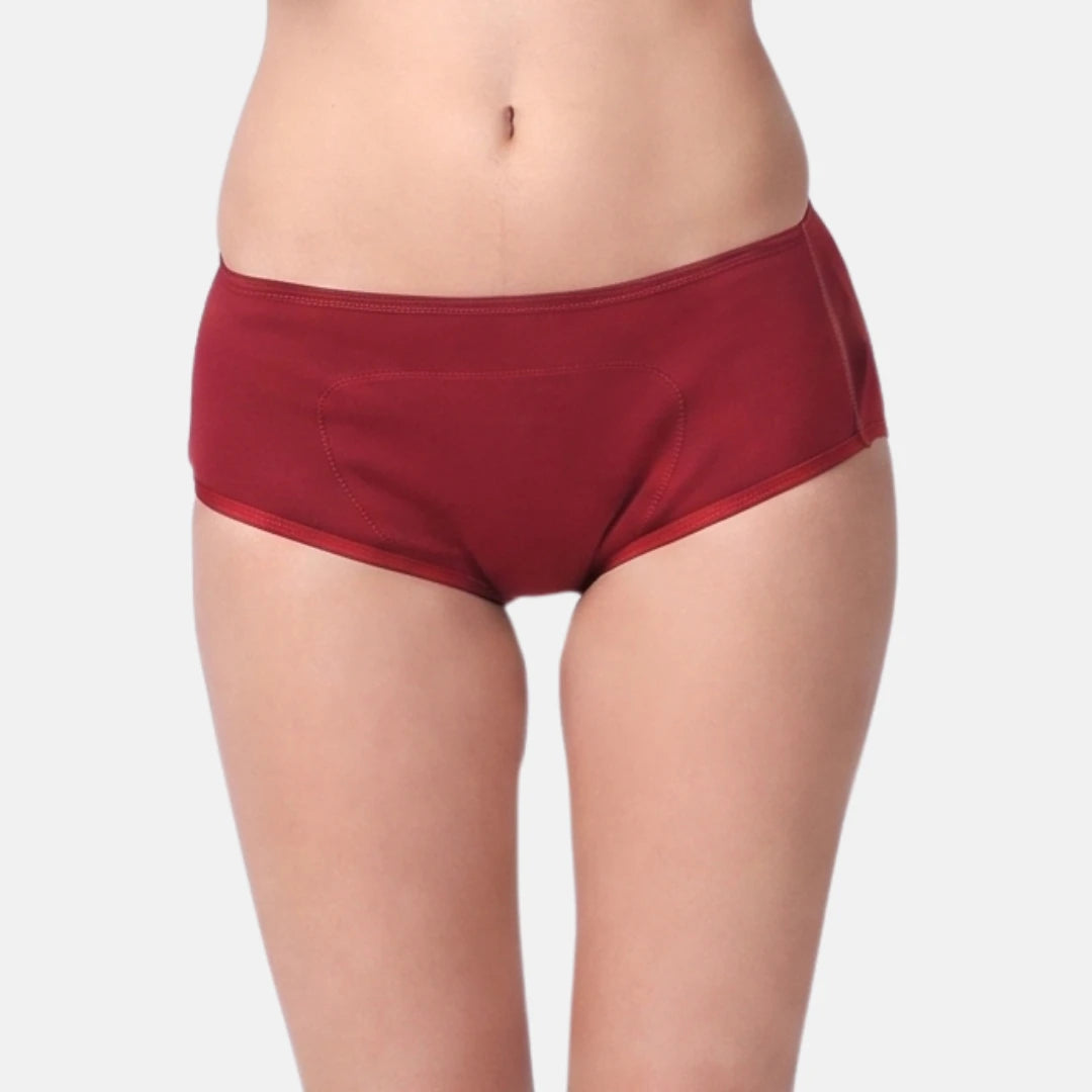 A model wearing a maroon boxer against a light gray background.