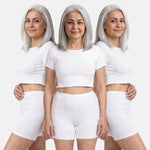 Woman wearing a three different poses with white crop top and white shorts on a white background