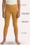 Mustard yellow leggings with text labels on a white background