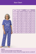 Woman wearing a navy hearts pajama set with a size chart
