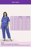 Woman wearing a navy hearts patterned outfit with a size chart