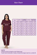 Woman wearing a wine outfit with a size chart
