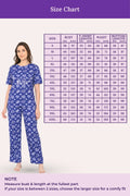 Woman wearing a navy hearts patterned outfit with a size chart