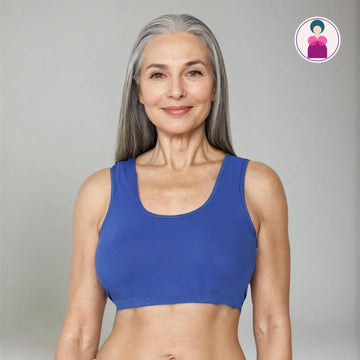 Image of senior woman wearing a blue sleep bra against a gray background - Know More.